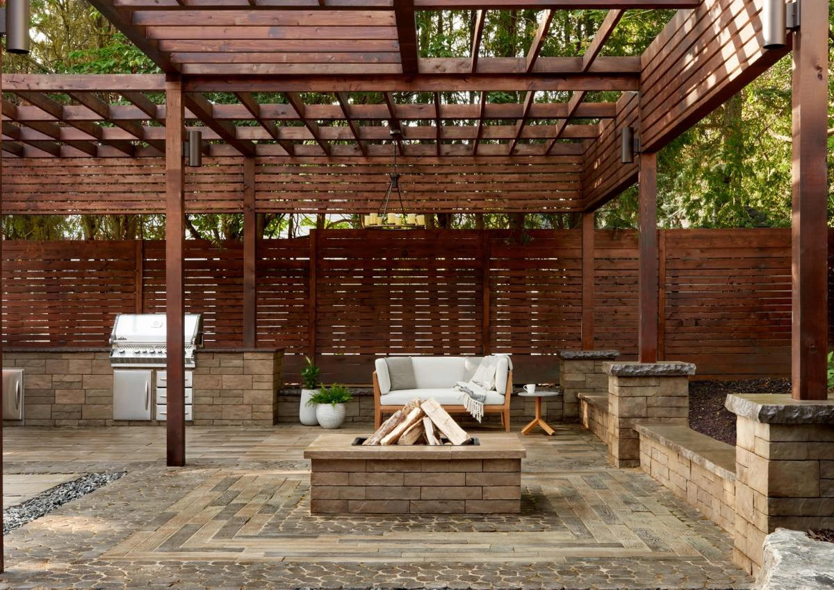 ChatGPT said: Modern backyard featuring a custom wooden pergola, outdoor seating, and fire pit crafted by skilled pergola builders in Fort Worth, TX.
