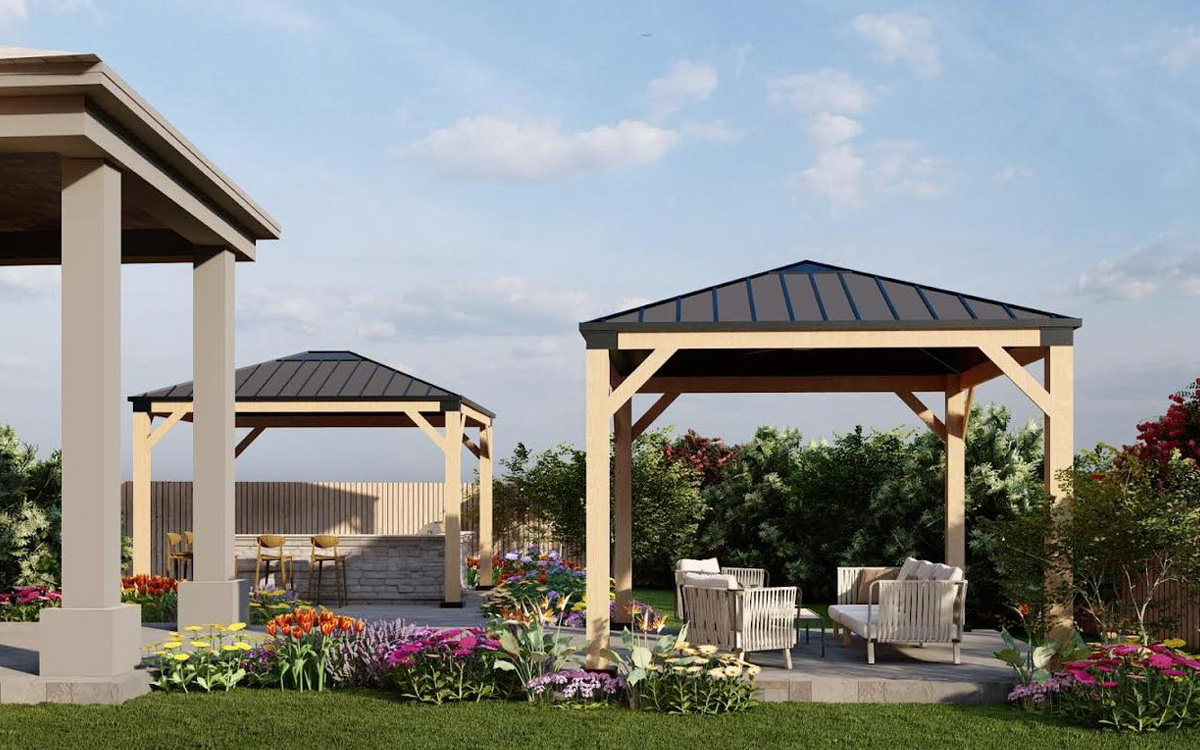 Backyard with two wooden pergolas, outdoor seating, and colorful outdoor living designs in Fort Worth, TX