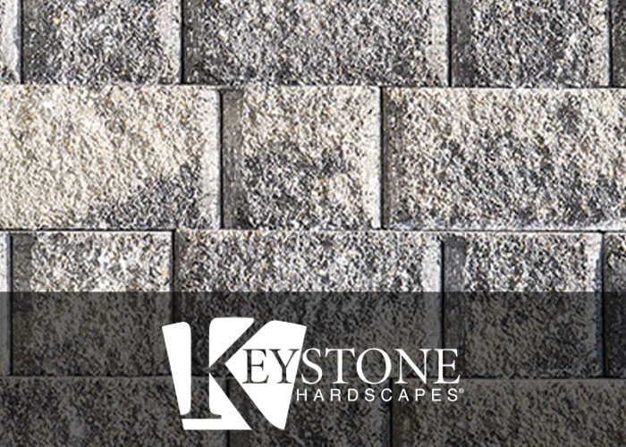 close-up of textured gray retaining wall blocks from Keystone Hardscapes used by retaining wall contractors in Fort Worth, TX