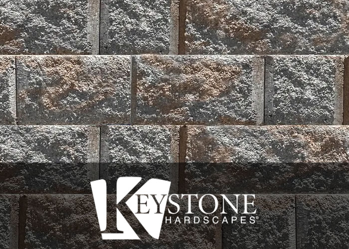close-up of dark gray and brown retaining wall blocks from Keystone Hardscapes used by retaining wall contractors in Fort Worth, TX