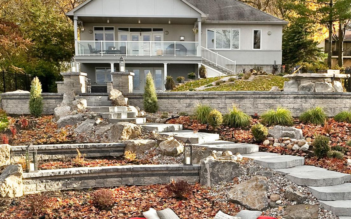 multi-level backyard with stone retaining walls, garden steps, and landscaping built by retaining wall contractors in Fort Worth, TX