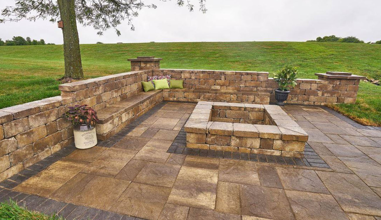 Holistic Patio Hardscaping Services in Fort Worth, TX - Holistic Patio Retaining Wall with Seating Ideas c1 corner patio with stone retaining wall benches and a square fire pit, displaying Retaining Wall with Seating Ideas for backyard designs