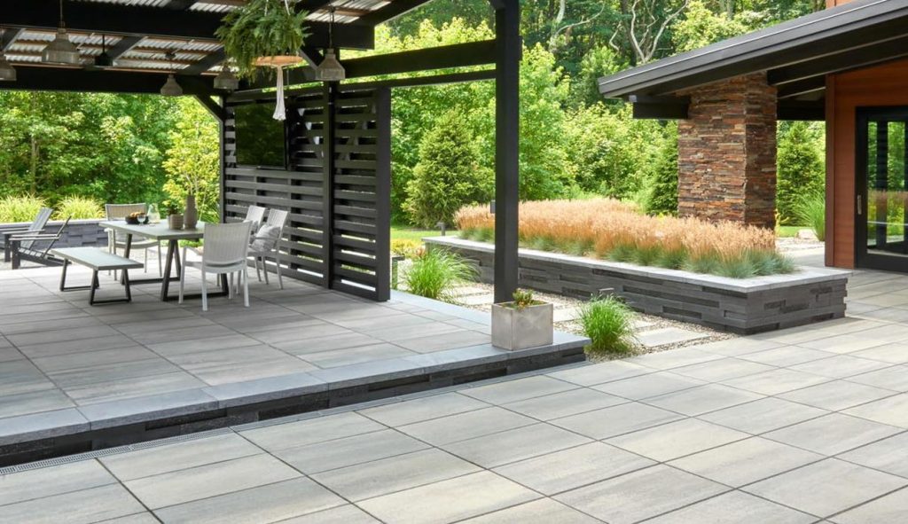 Holistic Patio Hardscaping Services in Fort Worth, TX - Holistic Patio Patio Decor Ideas 1 Modern covered patio highlights clean pavers, sleek pergola, dining space, and raised planters blending with nature.