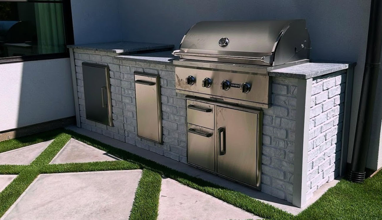 Holistic Patio Hardscaping Services in Fort Worth, TX - Modern Outdoor Kitchen Ideas Large curved stone masonry kitchen with extensive counter space overlooking a lush, manicured green landscape.